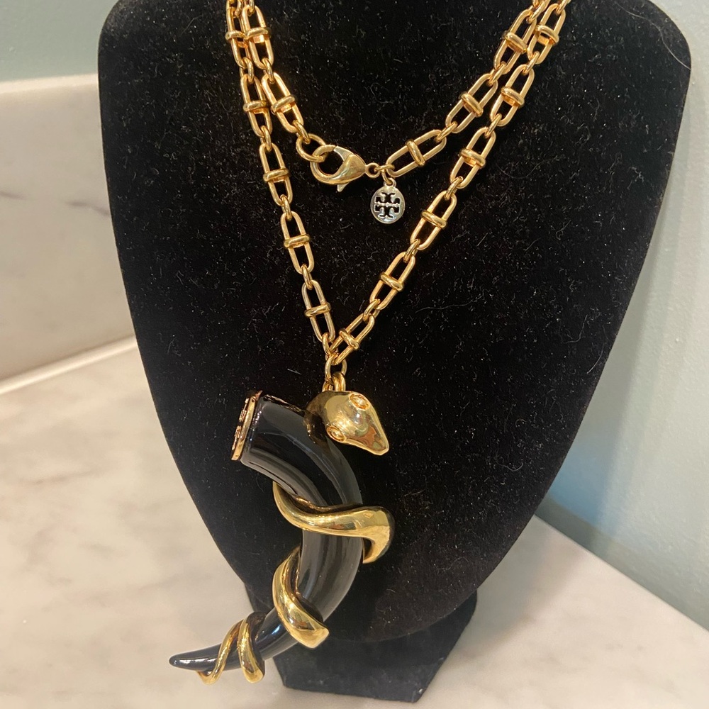 Tory Burch gold tone resin serpent horn
pendant necklace